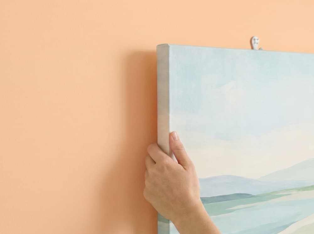 Canvas print being hung on a wall